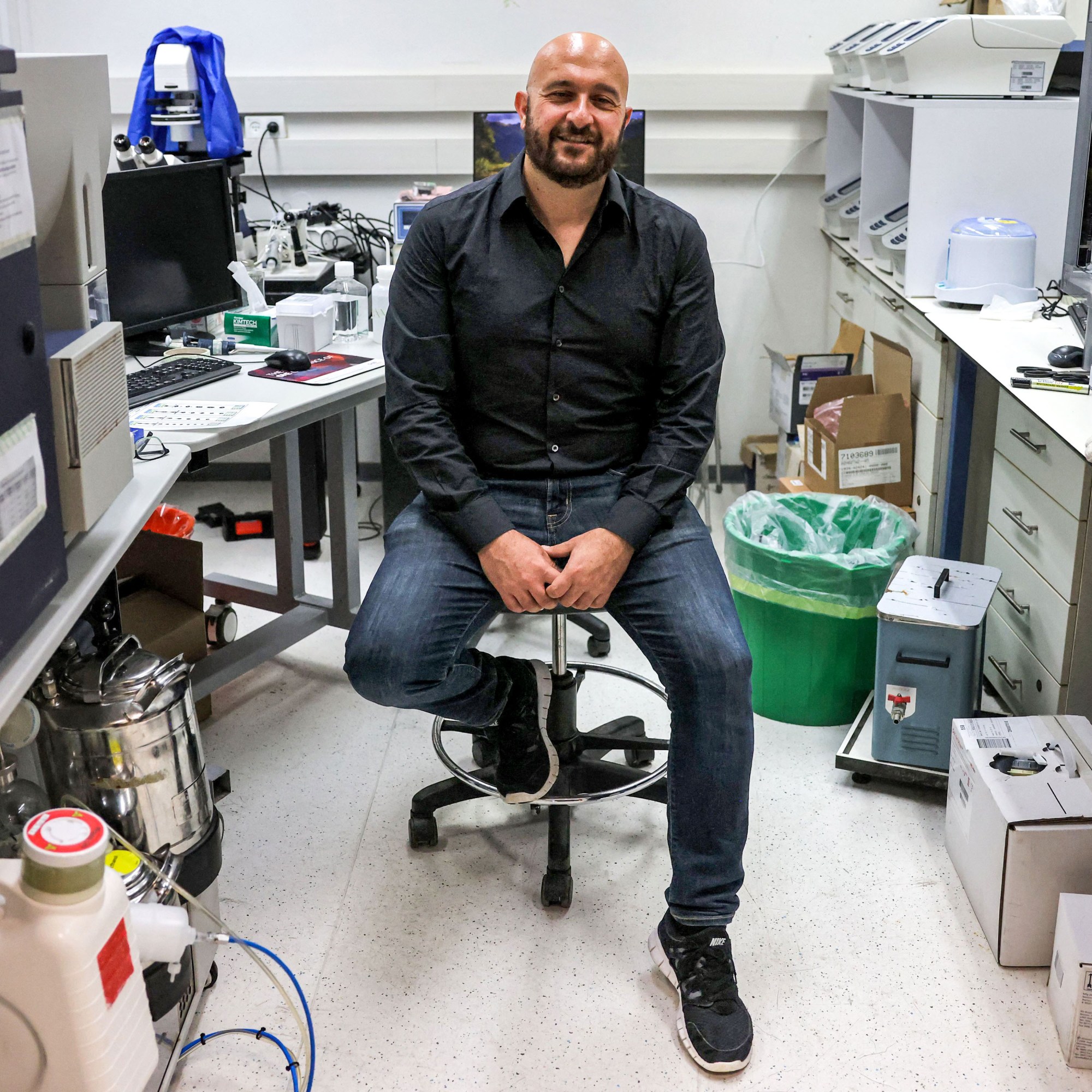 Jacob Hanna sitting in a lab space