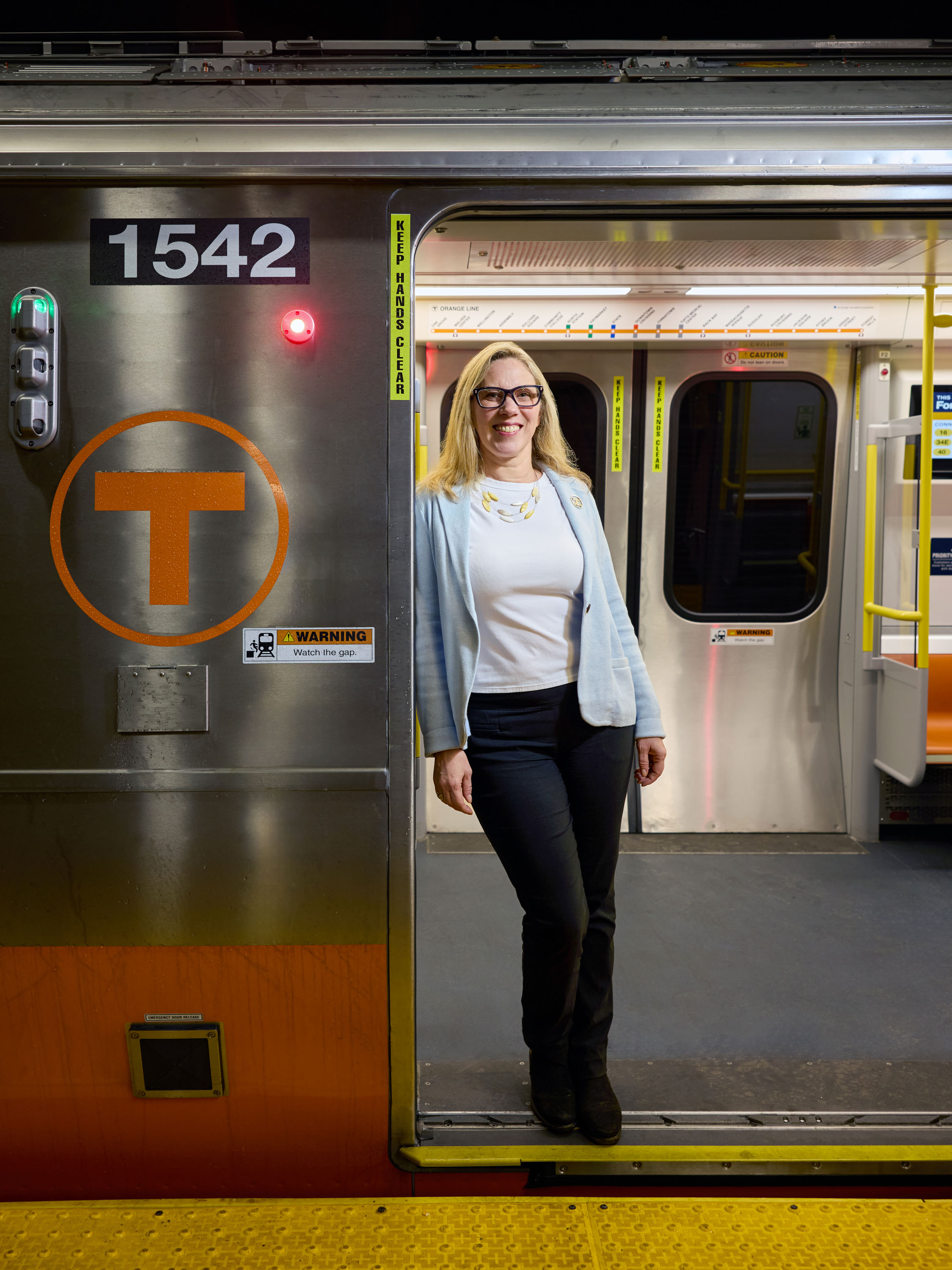 katie Choe standing in the doorway of an Orange Line car