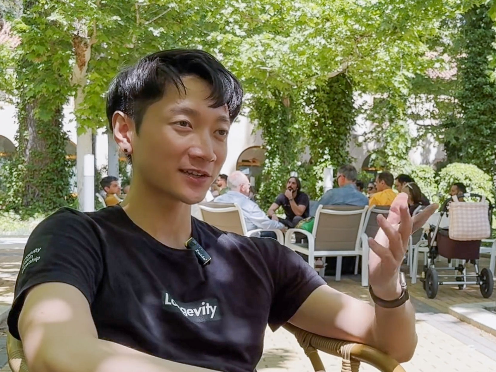 Nathan Cheng being interviewed outdoors at Longevity State Conference